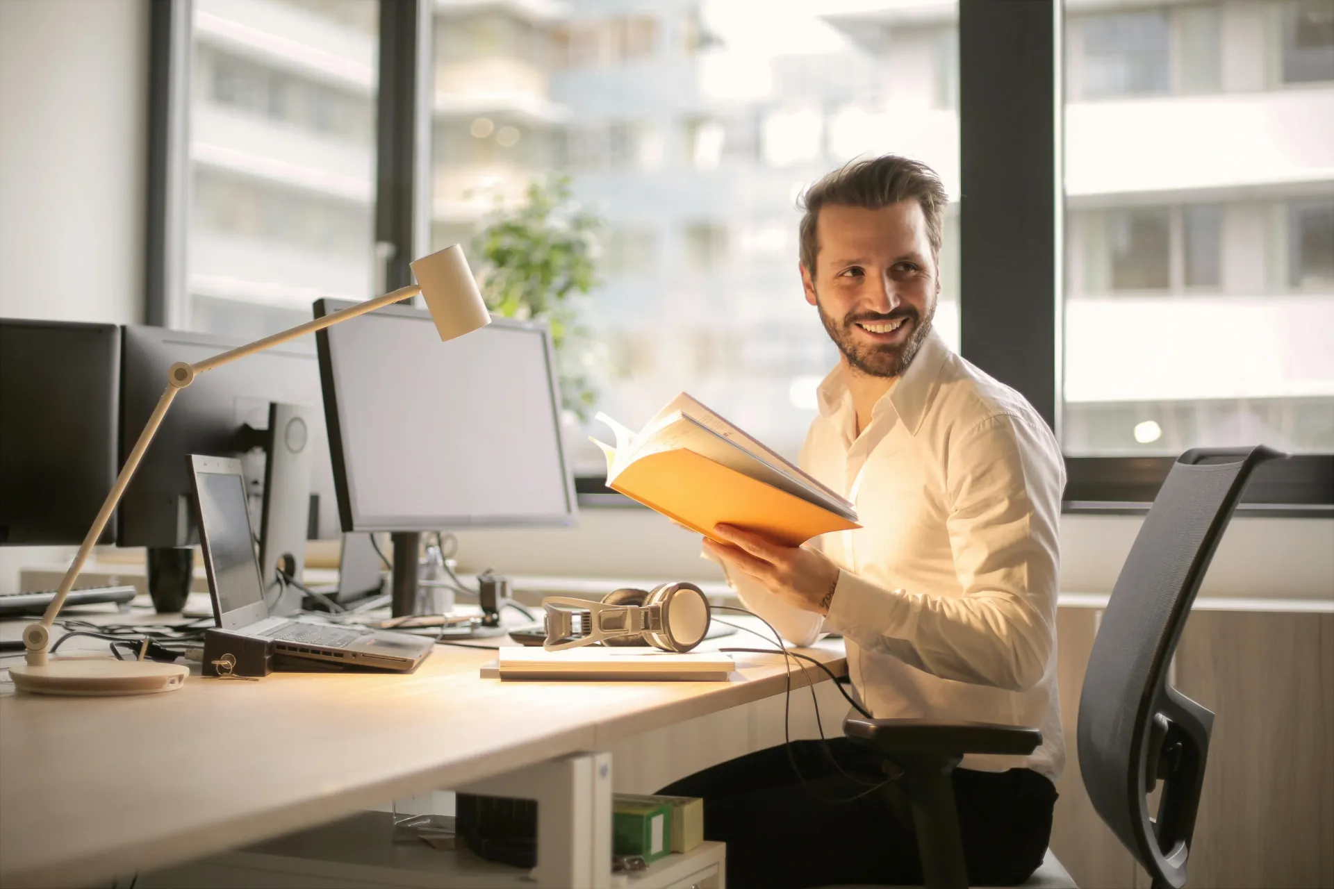 Man holding book at desk
